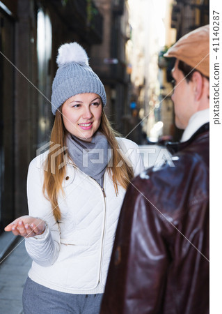 Man and woman talking at the streets in hats Man and woman talking at the streets in hats 41140287