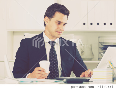 Successful businessman using laptop Successful businessman using laptop 41140331