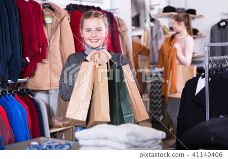Girl with shopping bags in clothes shop with mother 41140406