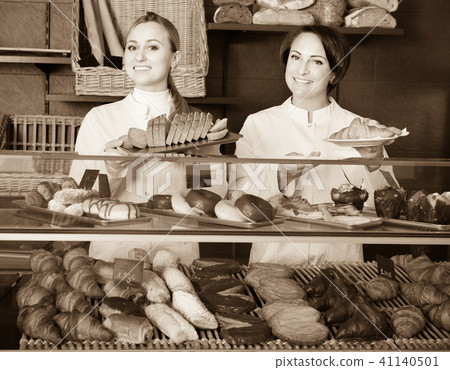 Female cooks demonstrating and selling pastry in the cafe Female cooks demonstrating and selling pastry in the cafe 41140501