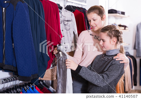 Girl with mum in clothing shop Girl with mum in clothing shop 41140507