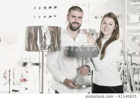 Portrait of family couple choosing floor lamp in shop Portrait of family couple choosing floor lamp in shop 41140835
