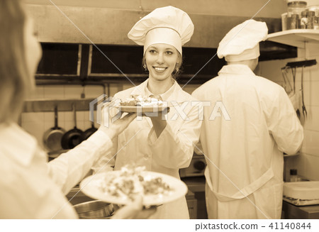 Waitress taking dish from kitchen Waitress taking dish from kitchen 41140844