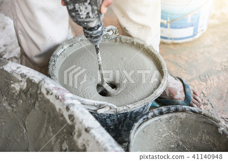 Cement or mortar is inside cement mixer in bucket. 41140948