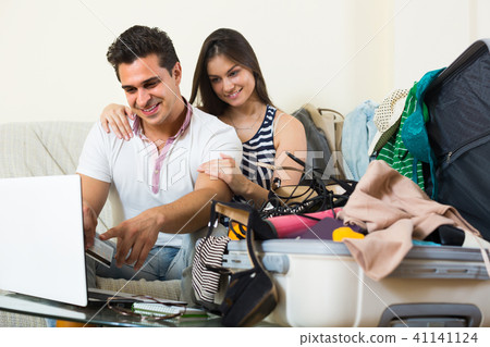 Couple preparing for voyage at home. Couple preparing for voyage at home. 41141124