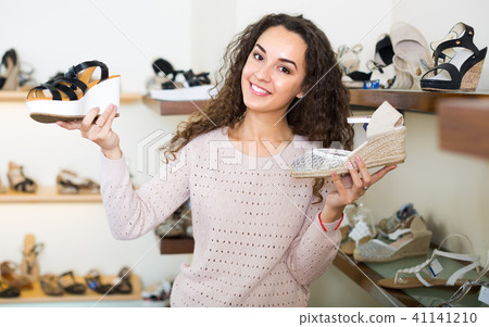 Young woman in a shoe store. Young woman in a shoe store. 41141210