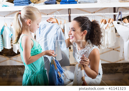 Mother with daughter buying clothes Mother with daughter buying clothes 41141323