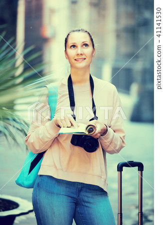 Woman is leafing through the booklet Woman is leafing through the booklet 41141530