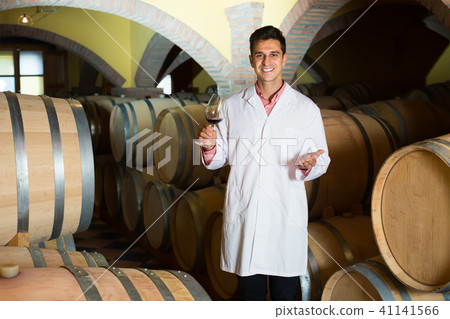 Man checking ageing process of red wine 41141566