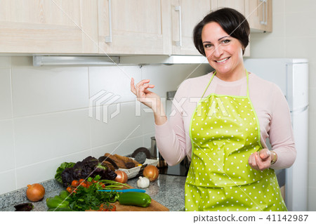 Portrait of cooking brunette housewife in apron - Stock Photo [41142987] -  PIXTA