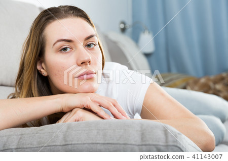 Sad woman is propped her cheeks with hands because she bored 41143007