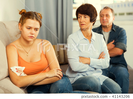 Mom and dad are supporting a sad daughter on sofa Mom and dad are supporting a sad daughter on sofa 41143206