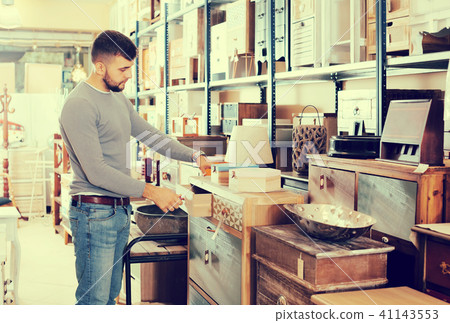 man choosing small cabinet man choosing small cabinet 41143553