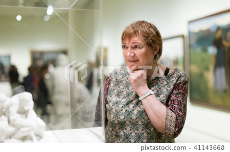 Woman visiting museum and enjoying sculture 41143668
