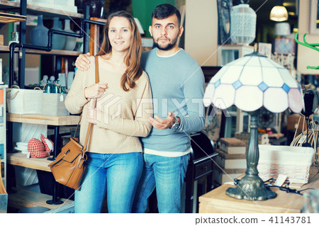 Happy couple in furnishings store 41143781