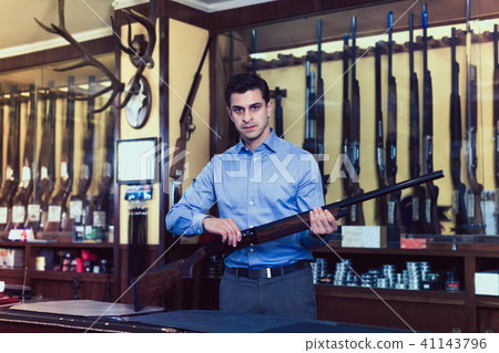 Salesman showing rifle Salesman showing rifle 41143796
