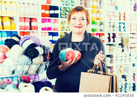 Female is standing in needlework store Female is standing in needlework store 41143838