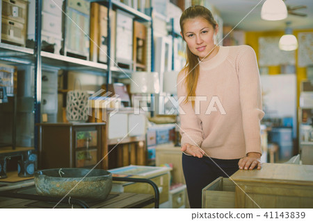 Female choosing commode in the furniture store Female choosing commode in the furniture store 41143839