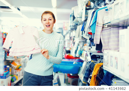 Woman awating for baby and choosing clothes 41143982