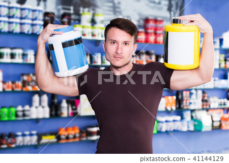 Guy holding sport food supplements Guy holding sport food supplements 41144129