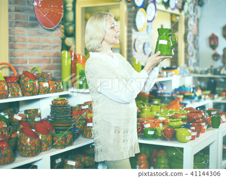 Customer posing with ceramic crockery at workshop Customer posing with ceramic crockery at workshop 41144306