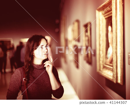 Adult woman visiting museum and pleased arts Adult woman visiting museum and pleased arts 41144307