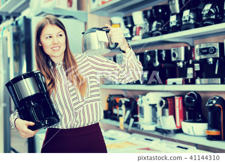 Young woman choosing coffee maker in shop Young woman choosing coffee maker in shop 41144310