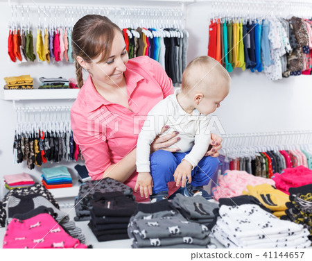 mother with kid is picking clothes mother with kid is picking clothes 41144657