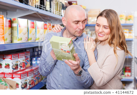 Family couple selection groats in grocery food store Family couple selection groats in grocery food store 41144672