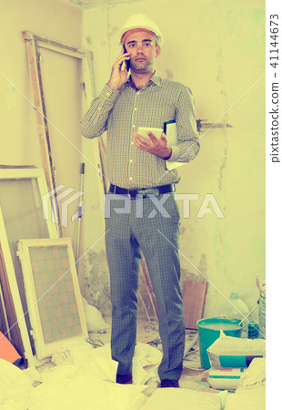 Man engineer talking on the mobile phone Man engineer talking on the mobile phone 41144673