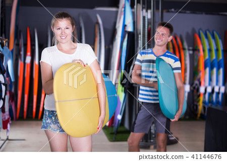 Portrait of happy girl with new surfboard Portrait of happy girl with new surfboard 41144676