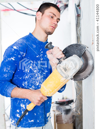 Male contractor using angle grinder Male contractor using angle grinder 41144800