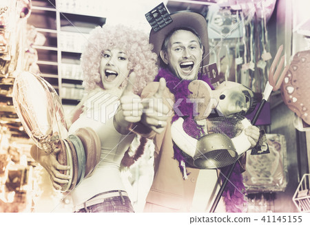 Couple giving thumbs as sign of successful preparation for fest 41145155