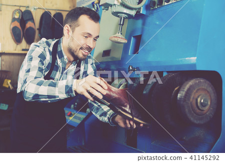 Male worker repairing shoe 41145292