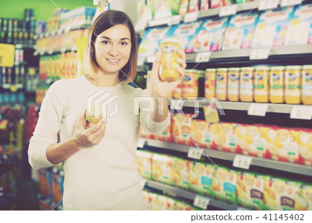 Girl choosing healthy baby food 41145402