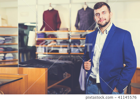man choosing casual jacket in fashion store 41145576