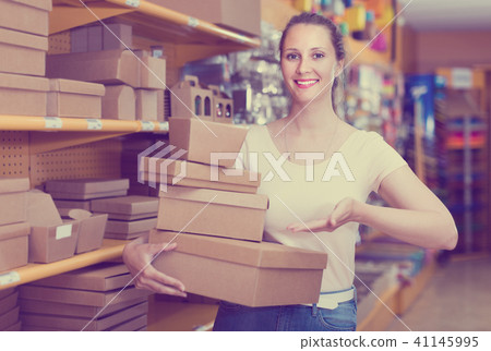 Girl with smile searching other gift containers Girl with smile searching other gift containers 41145995