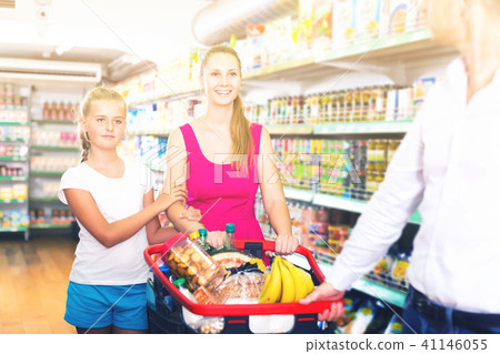 family of three choosing food in the grocery shop 41146055