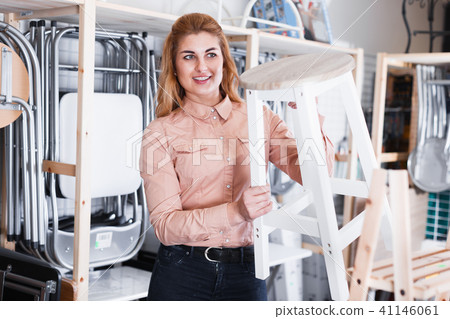 Woman choosing stool in store Woman choosing stool in store 41146061