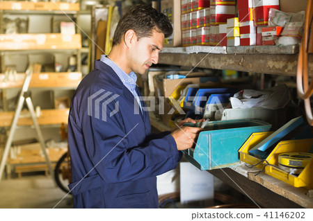 male is checking small details in boxes male is checking small details in boxes 41146202
