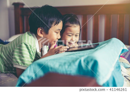 Asian children playing game on digital tablet. Asian children playing game on digital tablet. 41146261