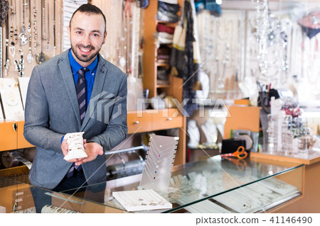 seller showing bracelets in the jewelry shop 41146490