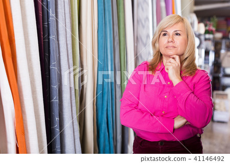 Smiling mature woman standing in the curtains shop 41146492