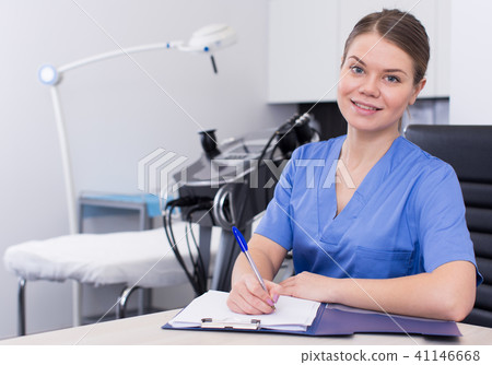 Beautician recording client cards 41146668