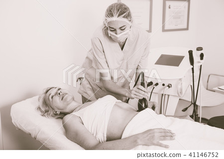 Woman receiving cryoliposuction Woman receiving cryoliposuction 41146752