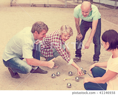 Cheerful males and females playing petanque 41146938