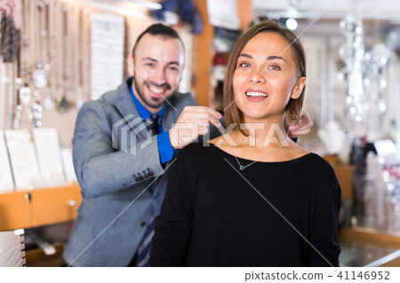 Woman trying stylish chainlet with pendants 41146952