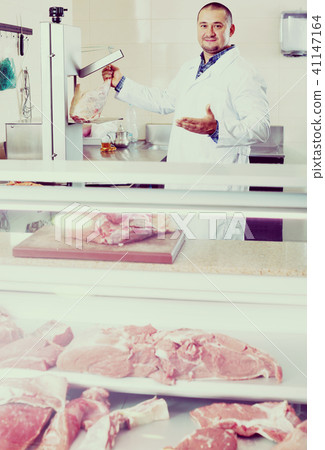 Male butcher in kosher section at supermarket Male butcher in kosher section at supermarket 41147164
