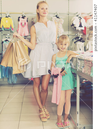 Nice mother with daughter holding packages Nice mother with daughter holding packages 41147407