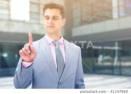Businessman pressing imaginary button Businessman pressing imaginary button 41147668